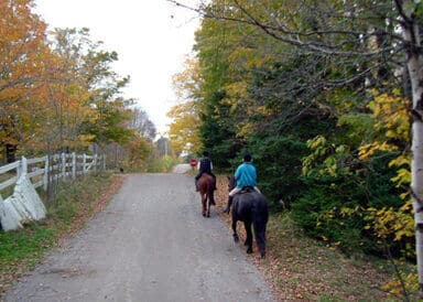 Two horse riders heading out on a hack at Hobby Horse Farm in Coldbrook Nova Scotia